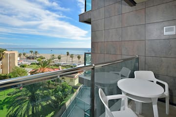 a balcony with a view of the ocean and a beach