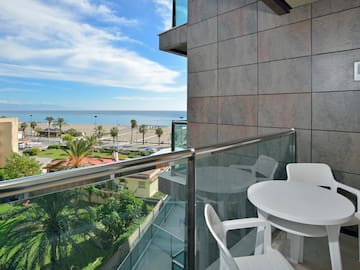 a balcony with a view of the ocean and a beach