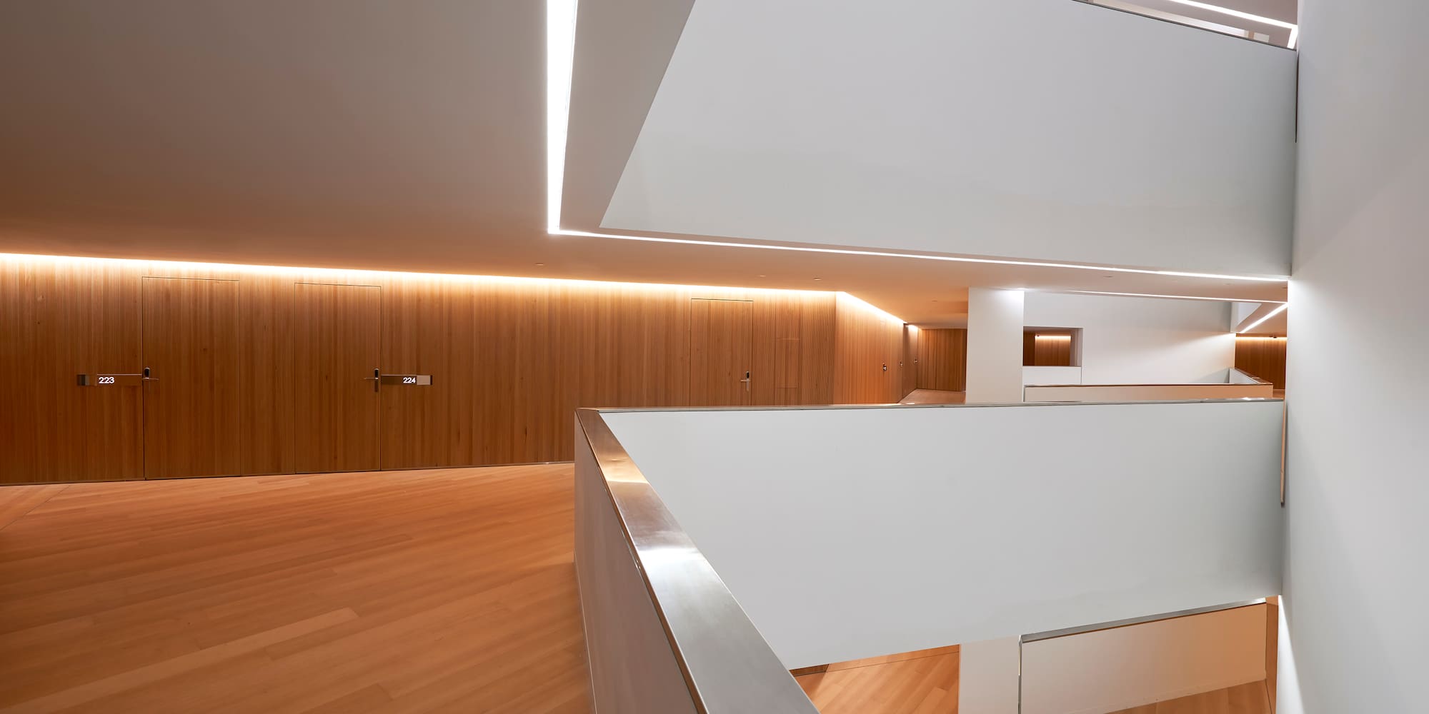 a room with a wood floor and white walls