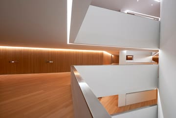 a room with a wood floor and white walls