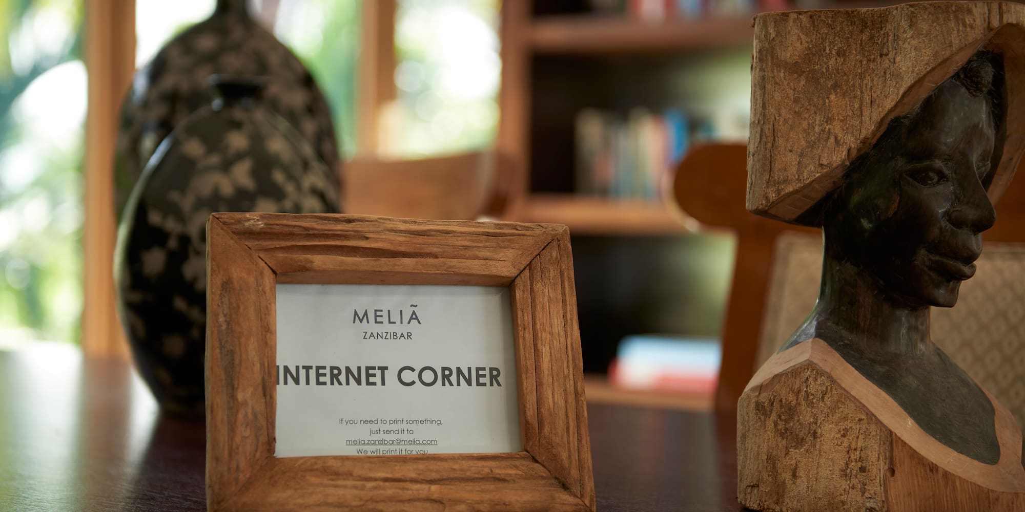 a wood frame and a statue on a table