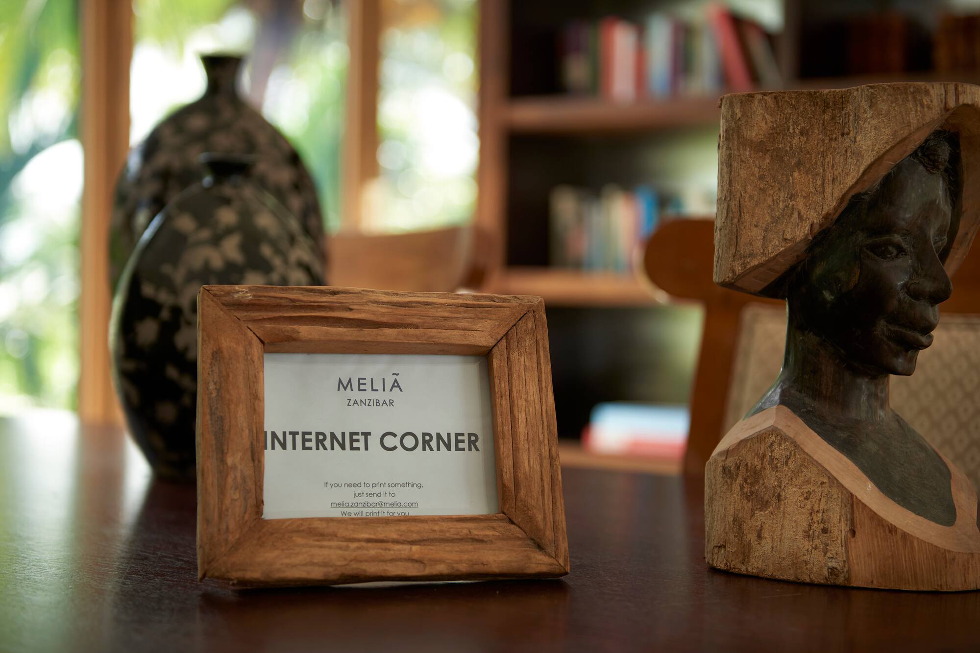 a wood frame and a statue on a table