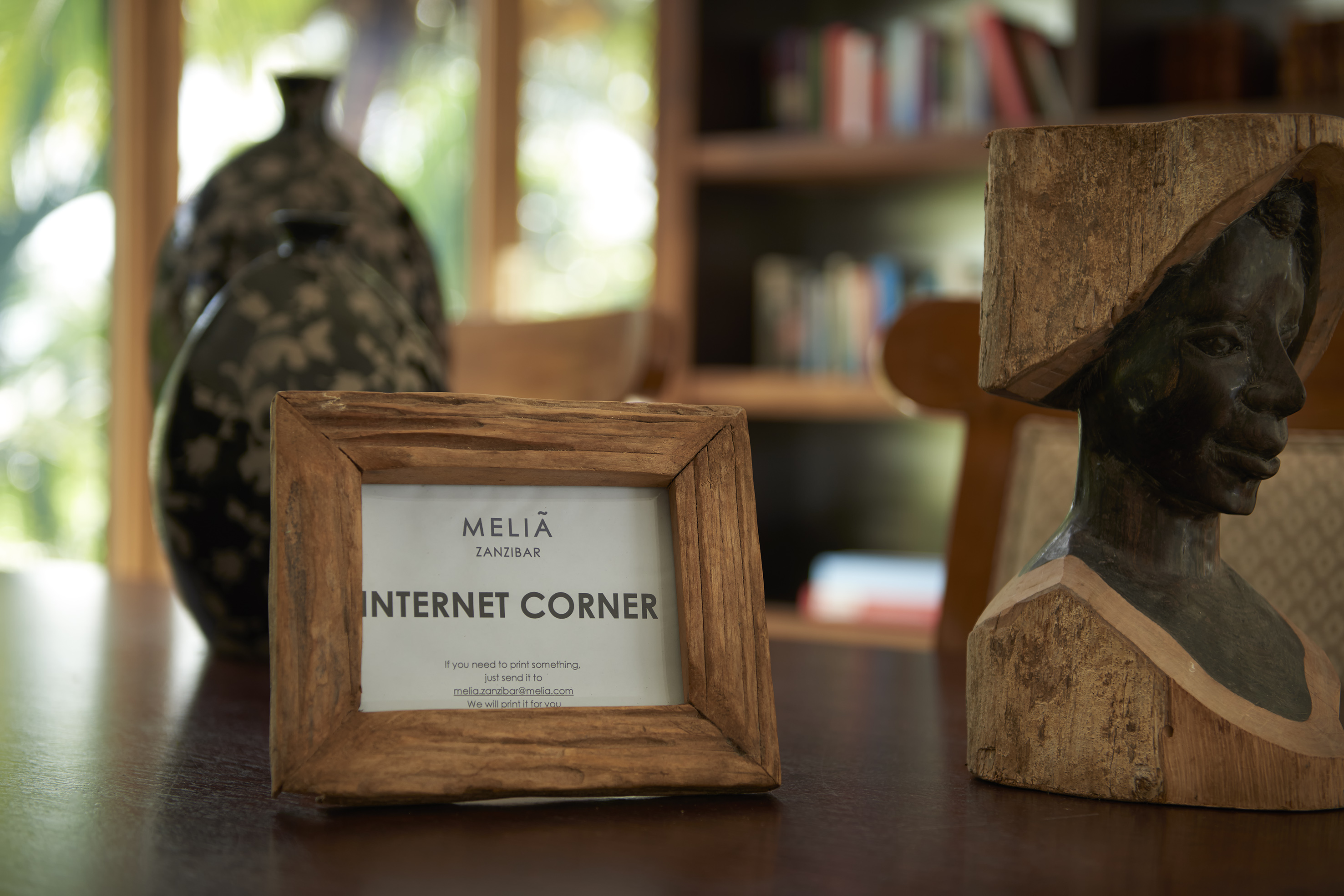 a wood frame and a statue on a table