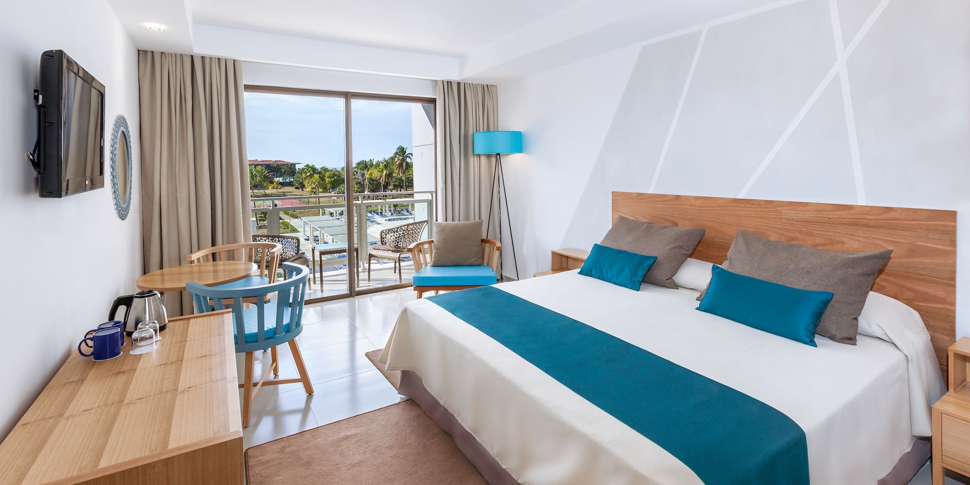 a bedroom with a bed and a table and chairs