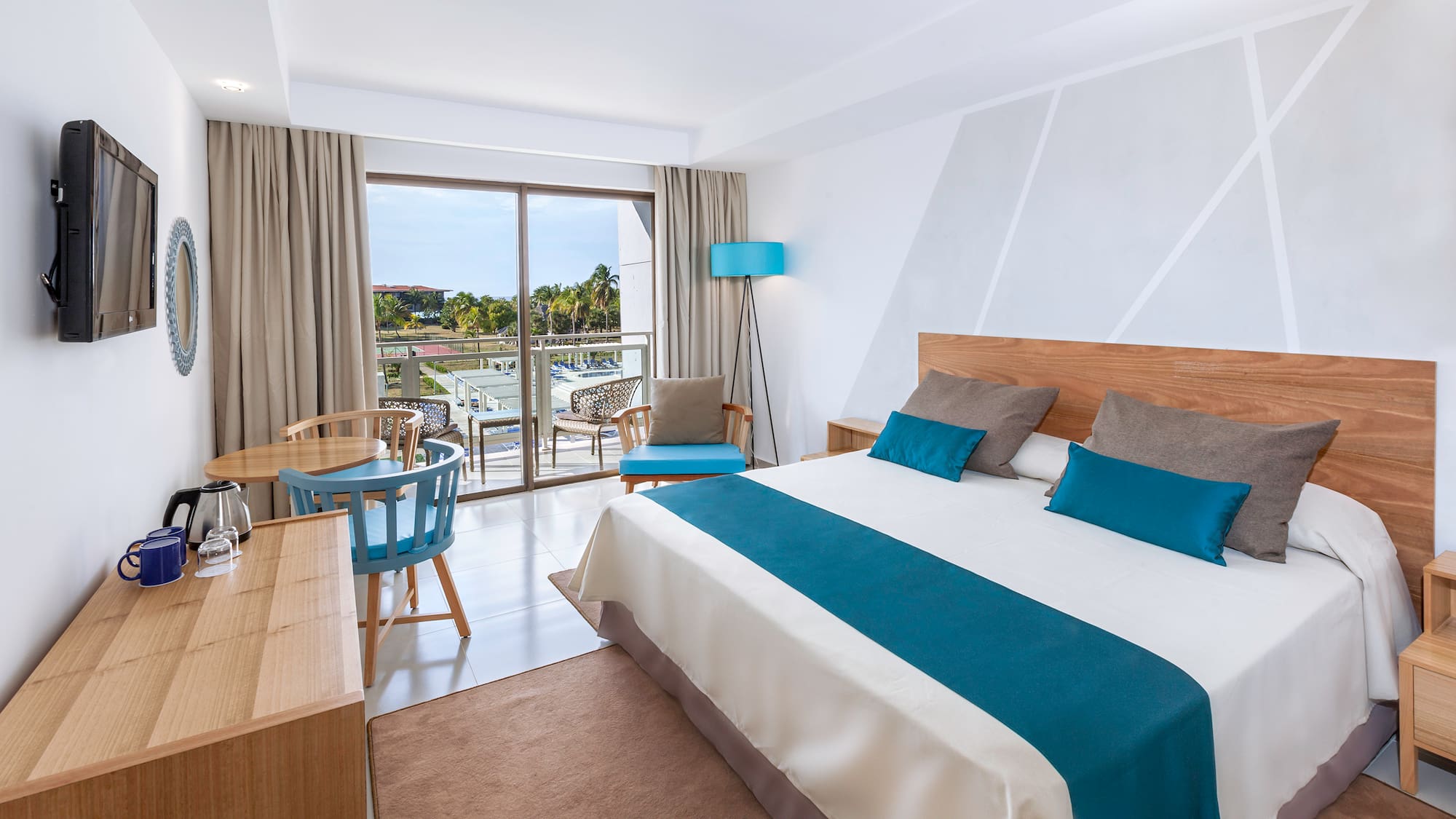 a bedroom with a bed and a table and chairs