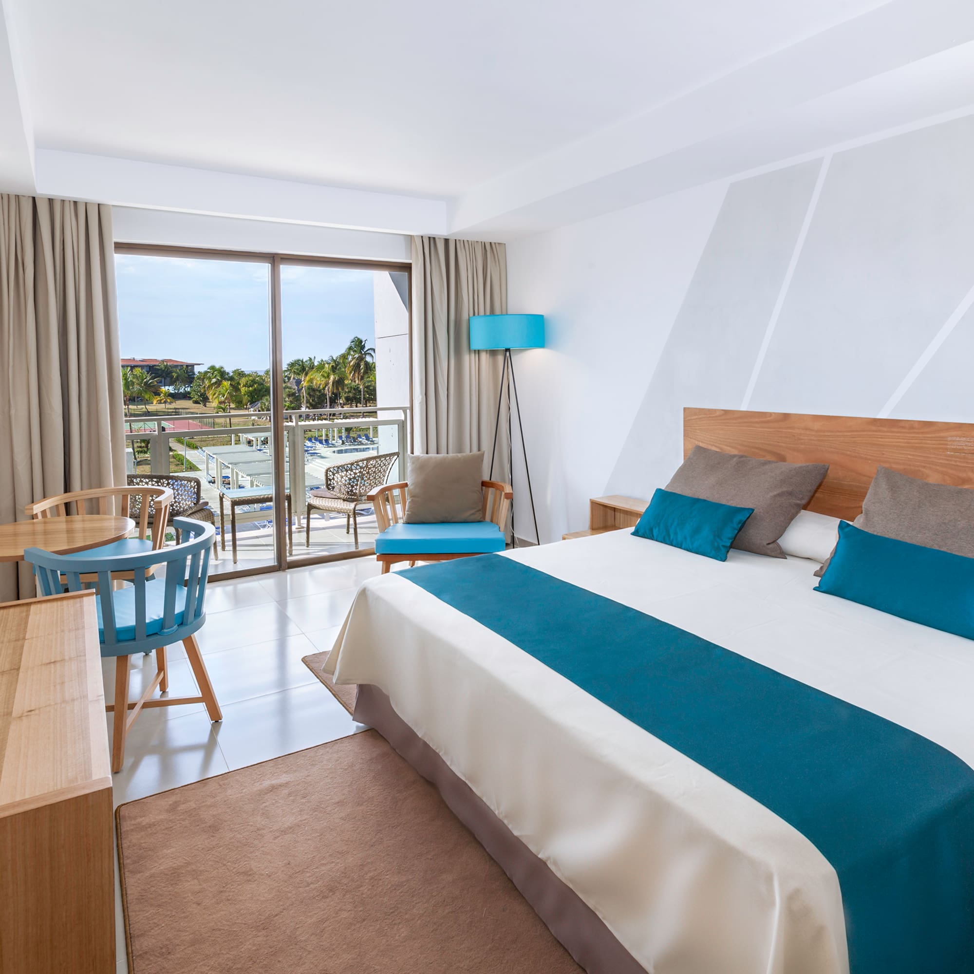 a bedroom with a bed and a table and chairs