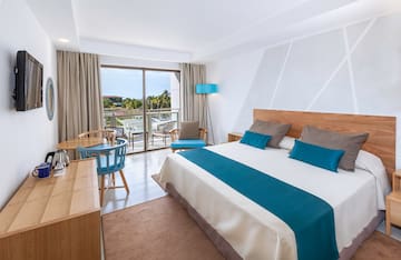 a bedroom with a bed and a table and chairs