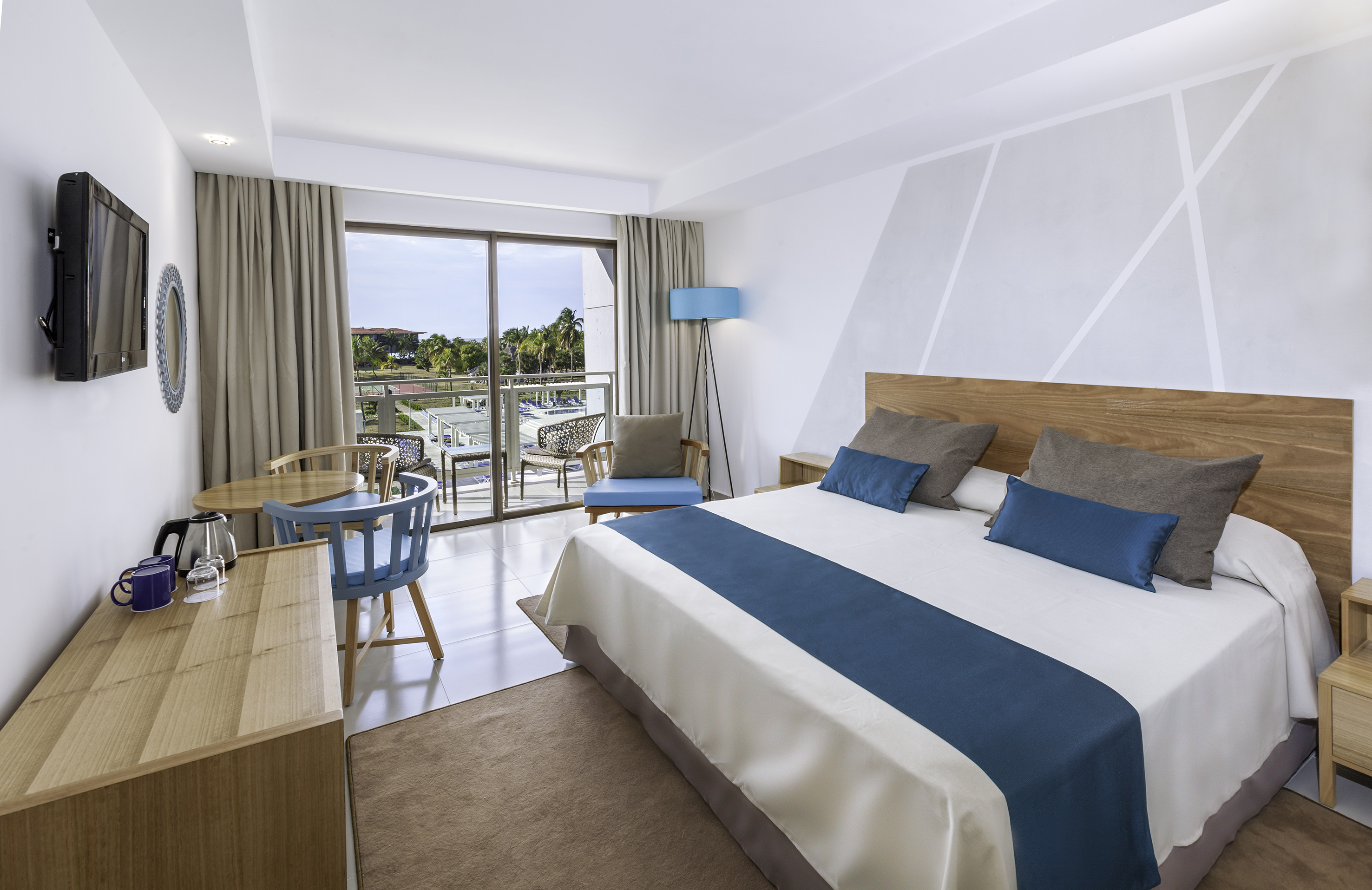 a bedroom with a bed and a table and chairs