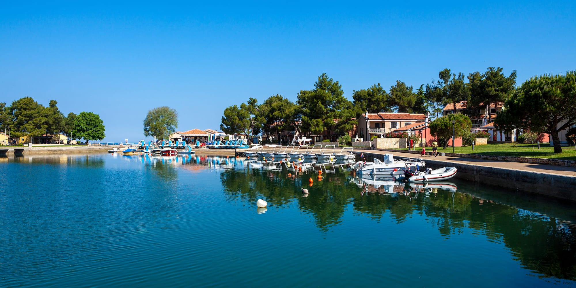 a body of water with boats and buildings on the side