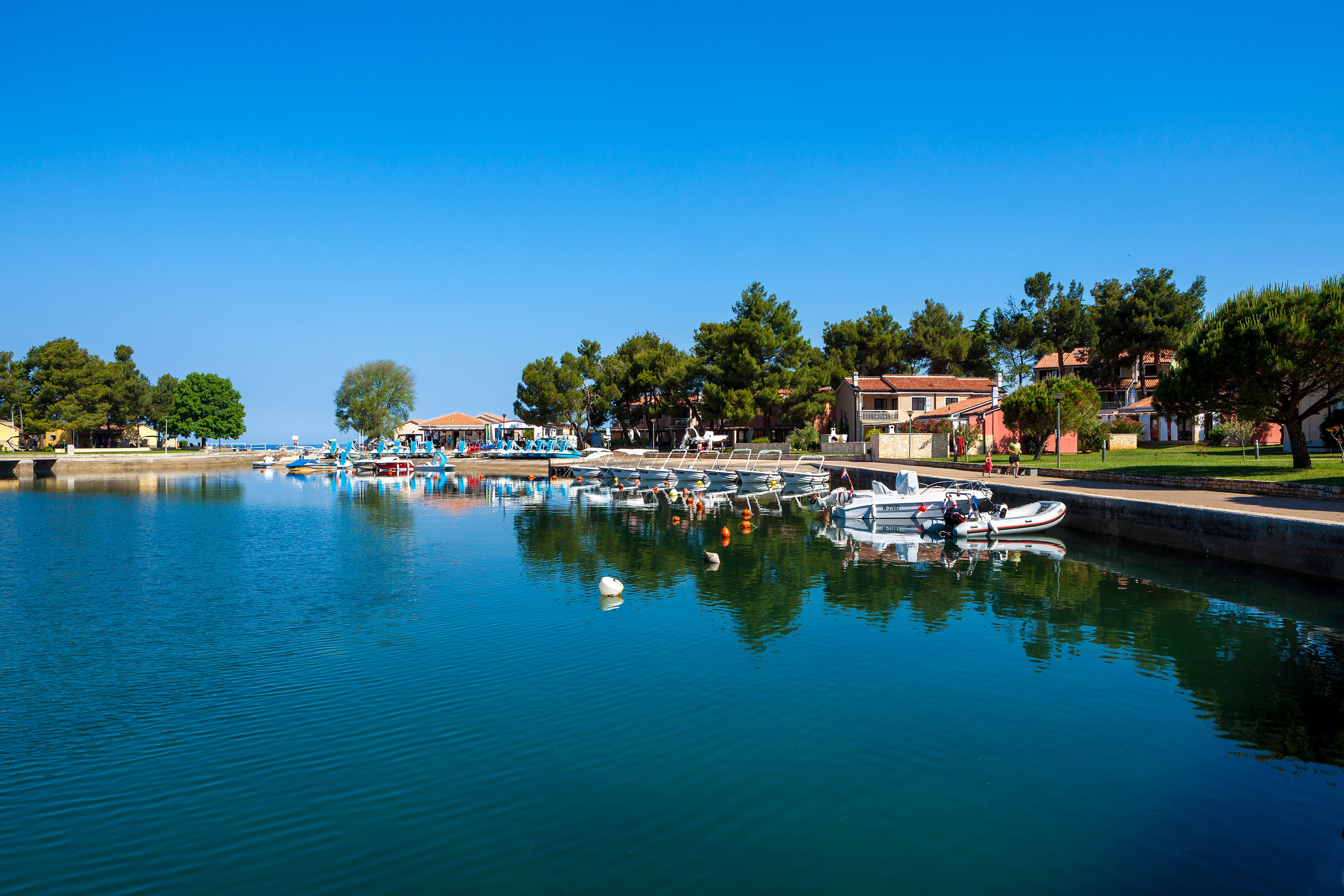 a body of water with boats and buildings on the side