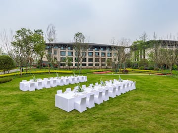 a large group of tables in a grassy area