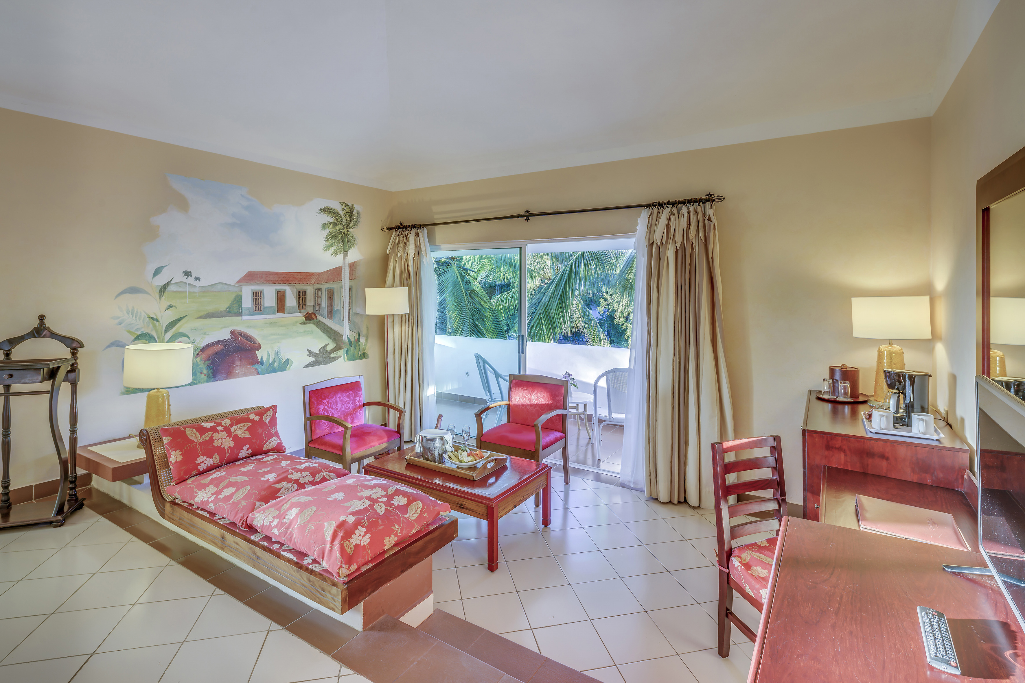 a room with a couch and chairs