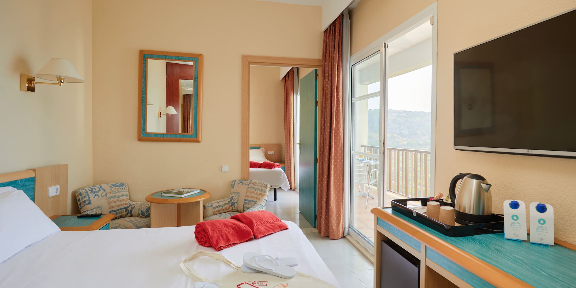 a room with a bed and a television