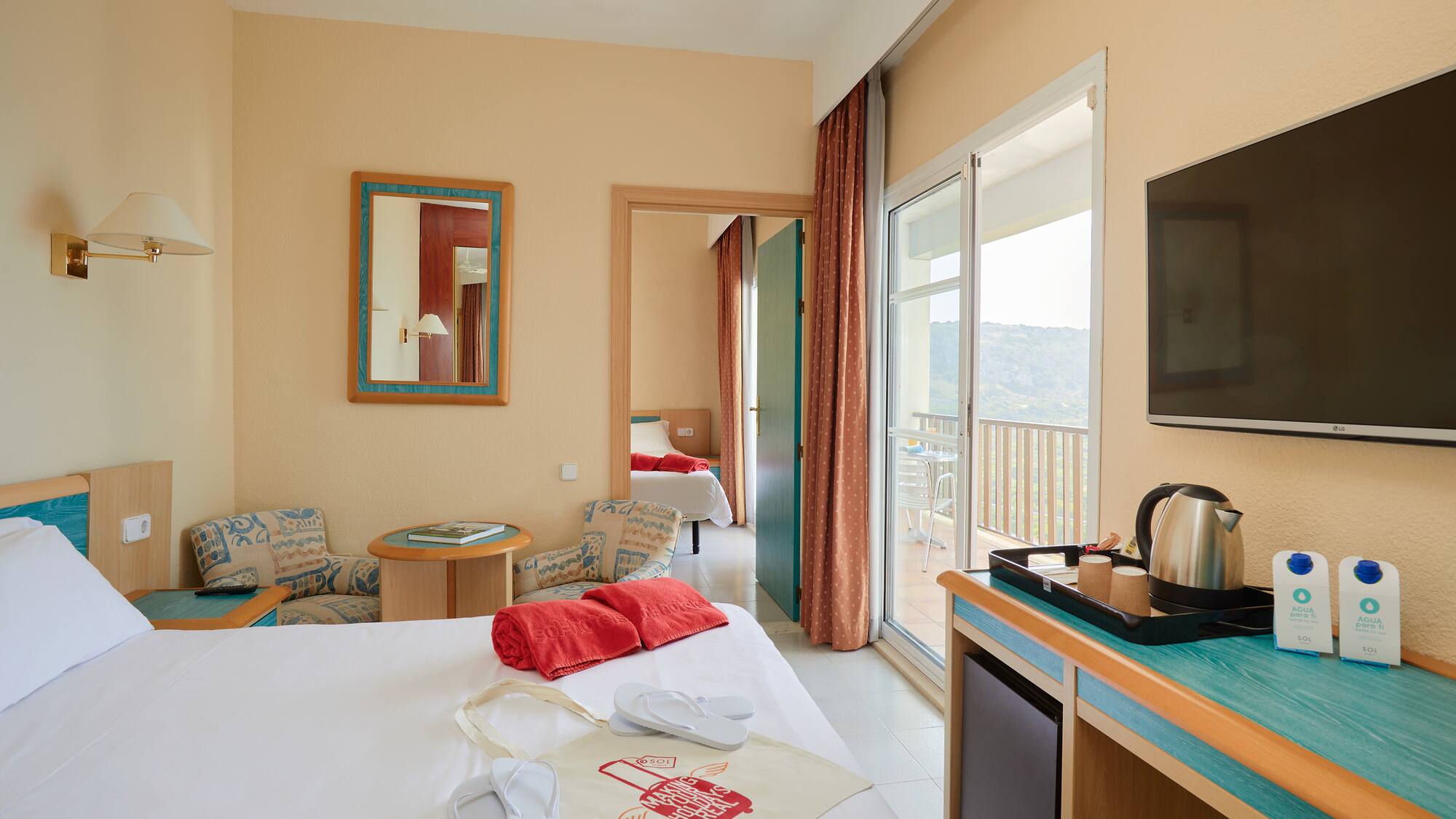 a room with a bed and a television