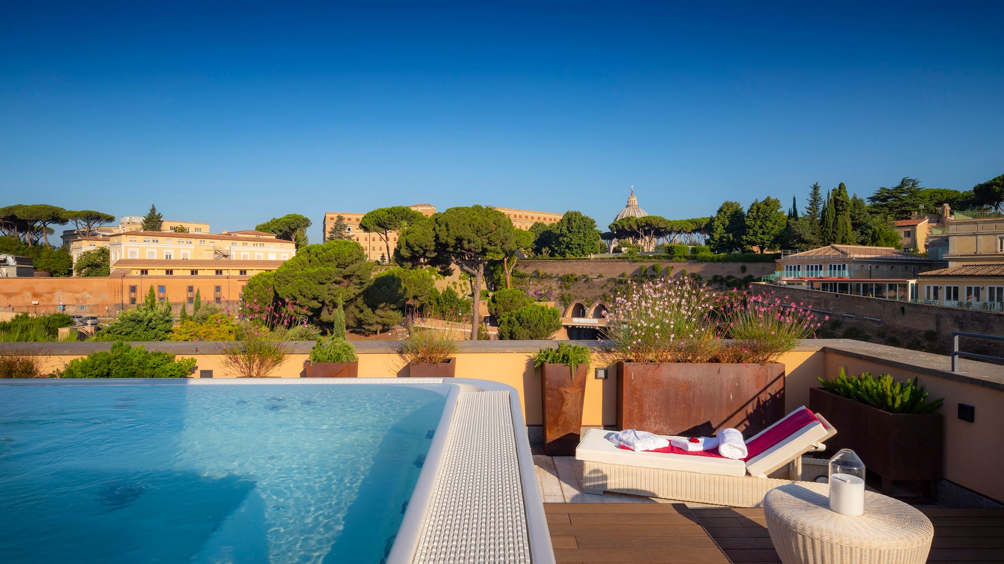 a pool on a rooftop with a view of a city and buildings