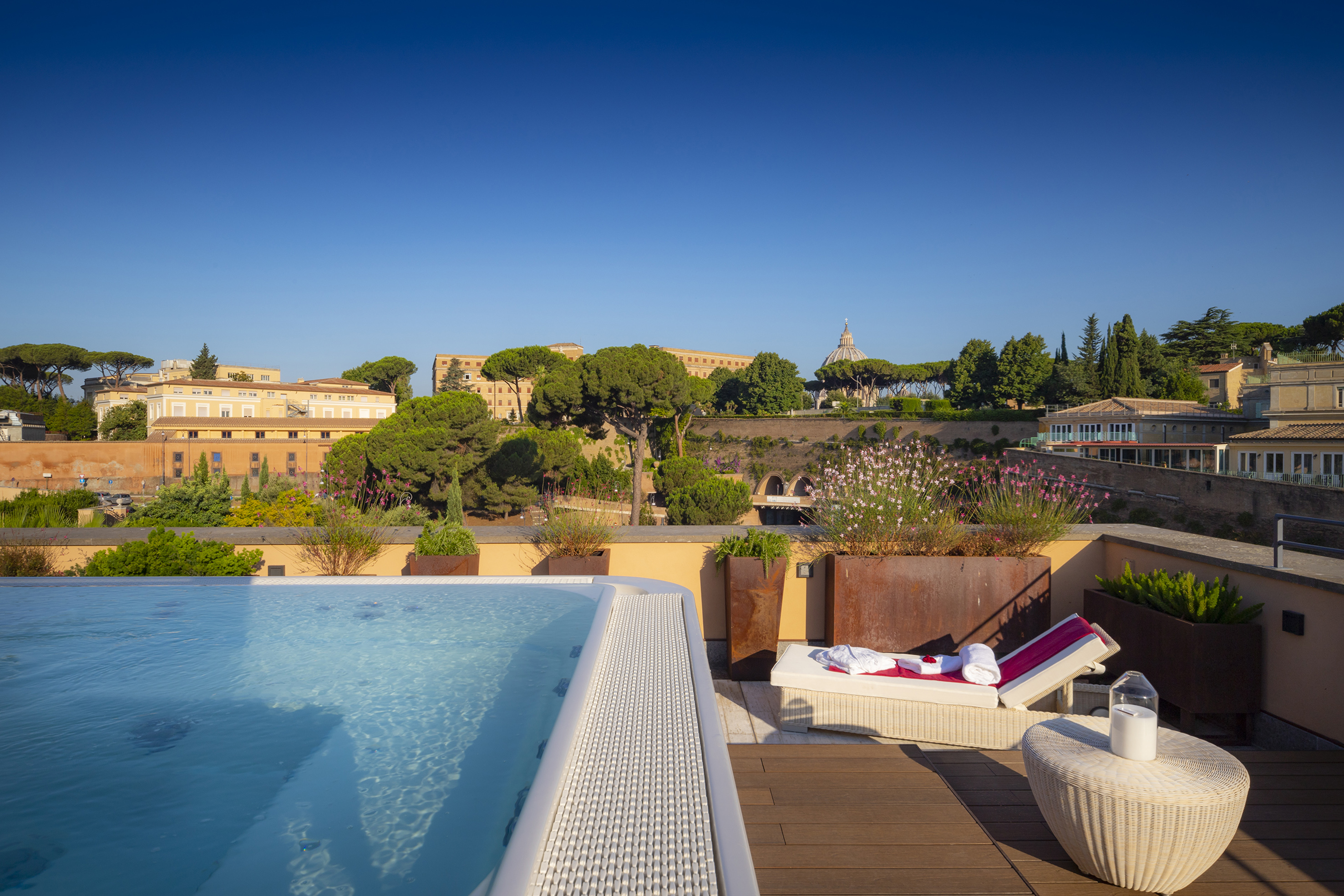 a pool on a rooftop with a view of a city and buildings