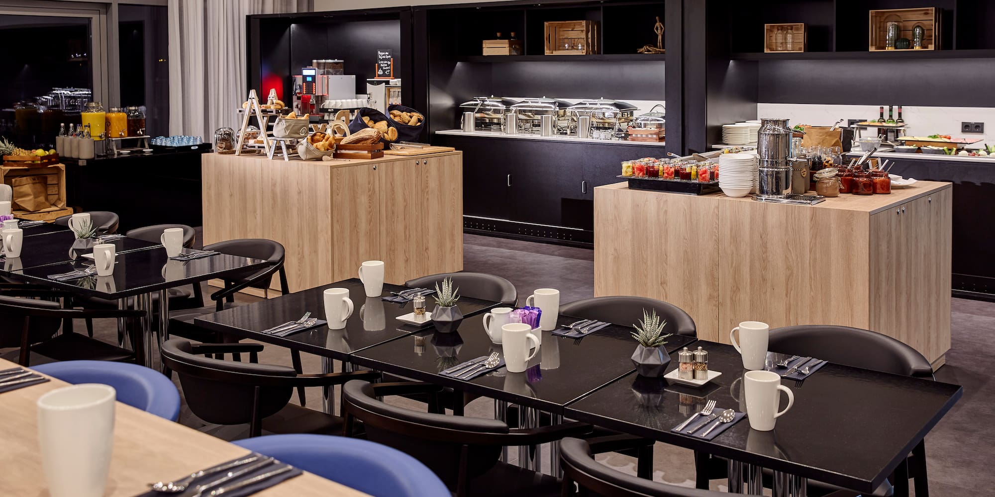 a room with black tables and blue chairs