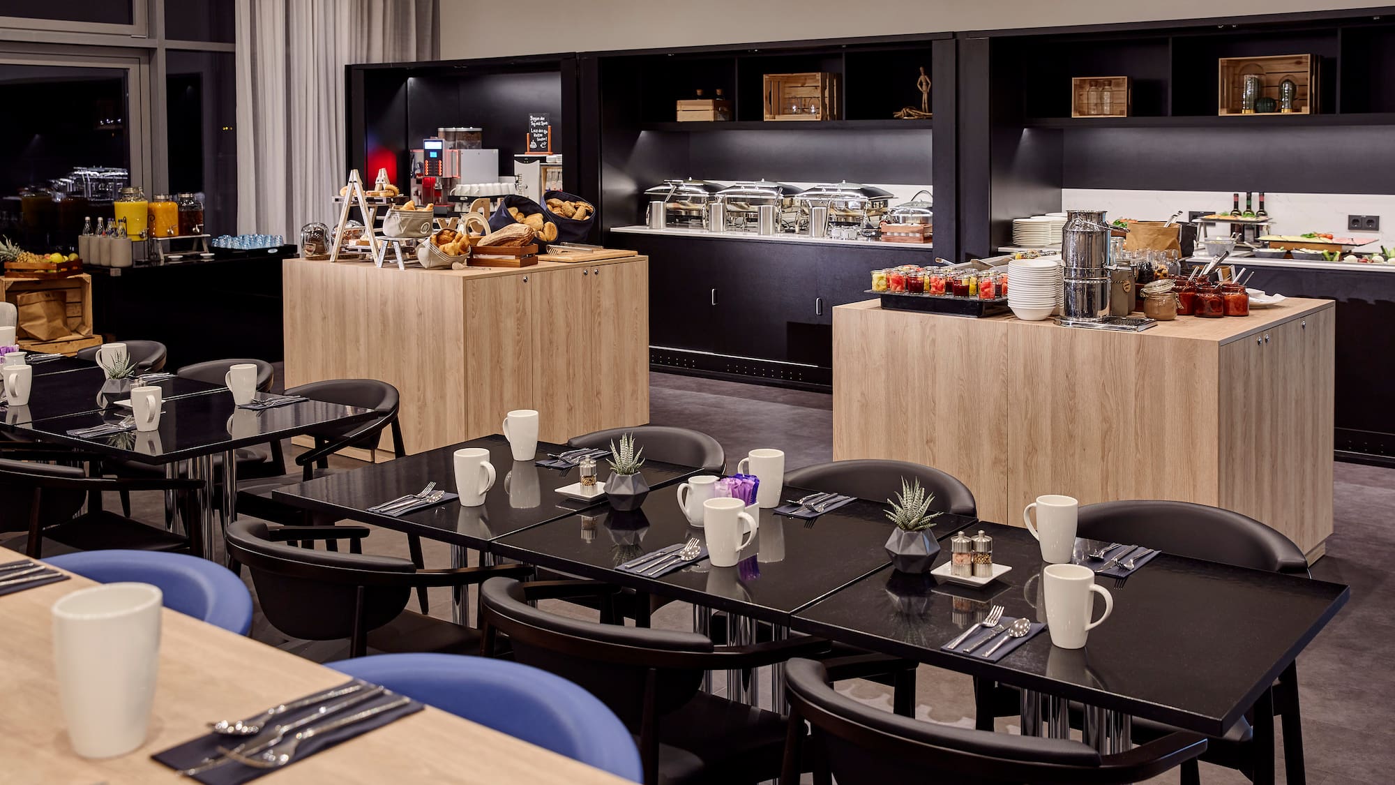 a room with black tables and blue chairs