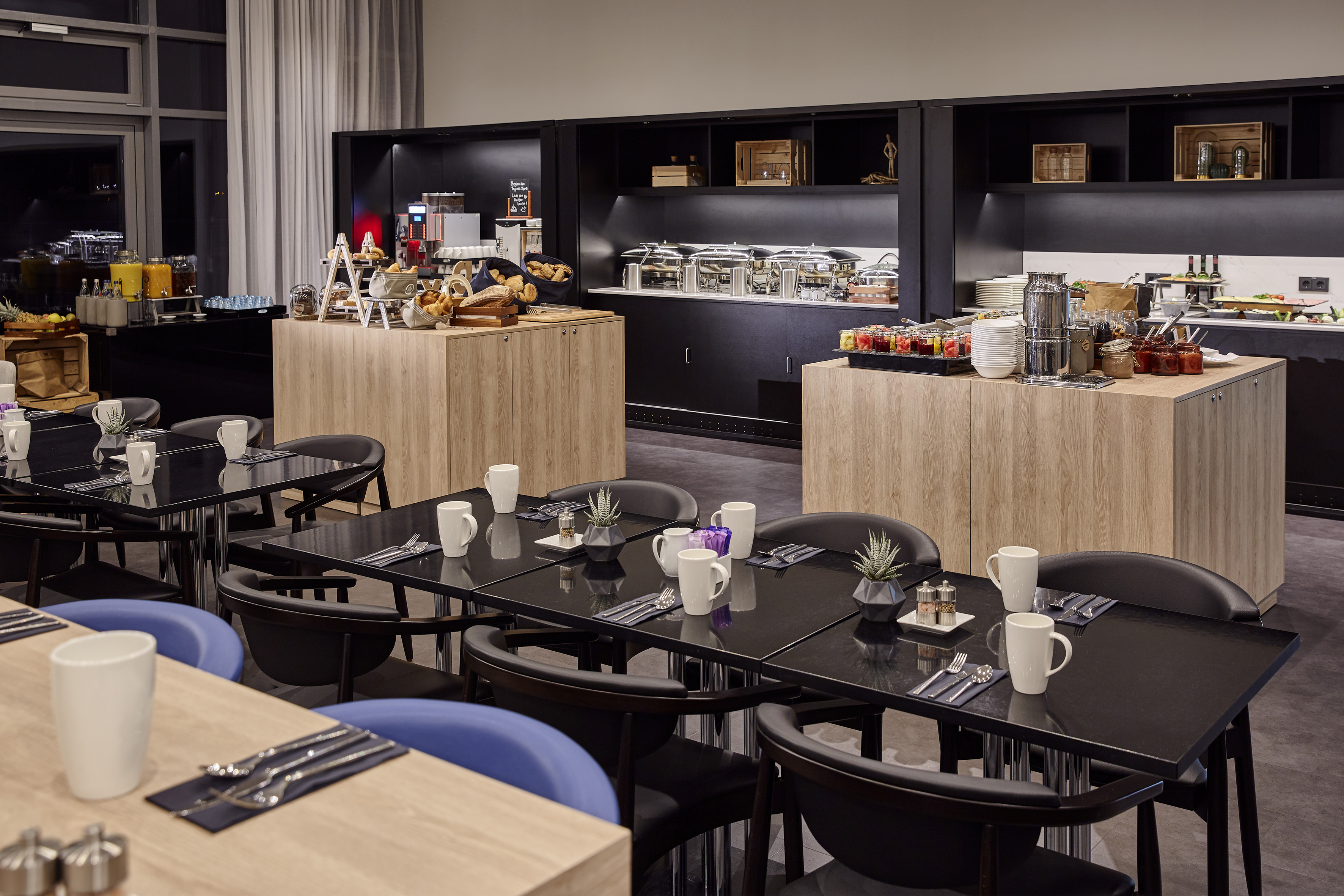 a room with black tables and blue chairs