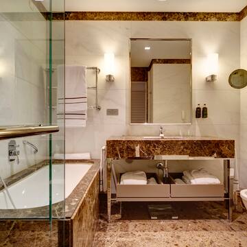 a bathroom with marble countertop and a bathtub