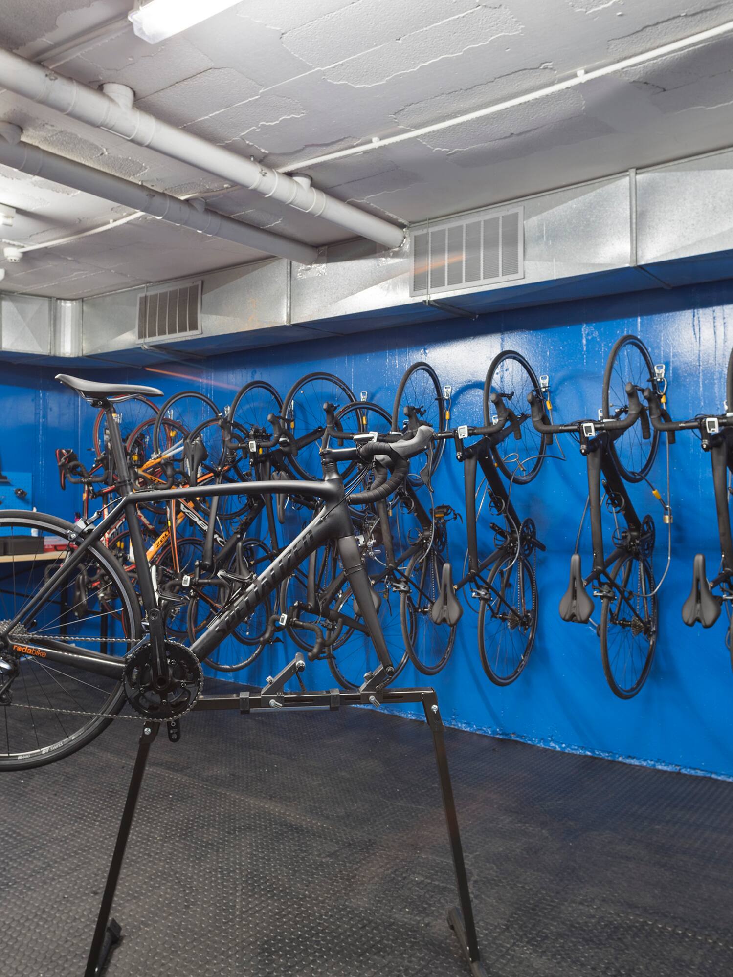 a bicycle rack with many bicycles on the wall