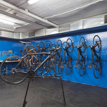 a bicycle rack with many bicycles on the wall