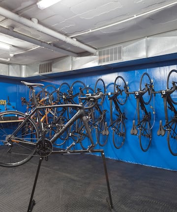 a bicycle rack with many bicycles on the wall