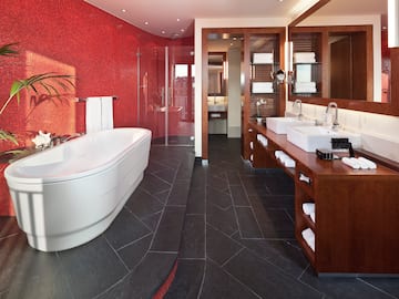 a bathroom with a large tub and sinks