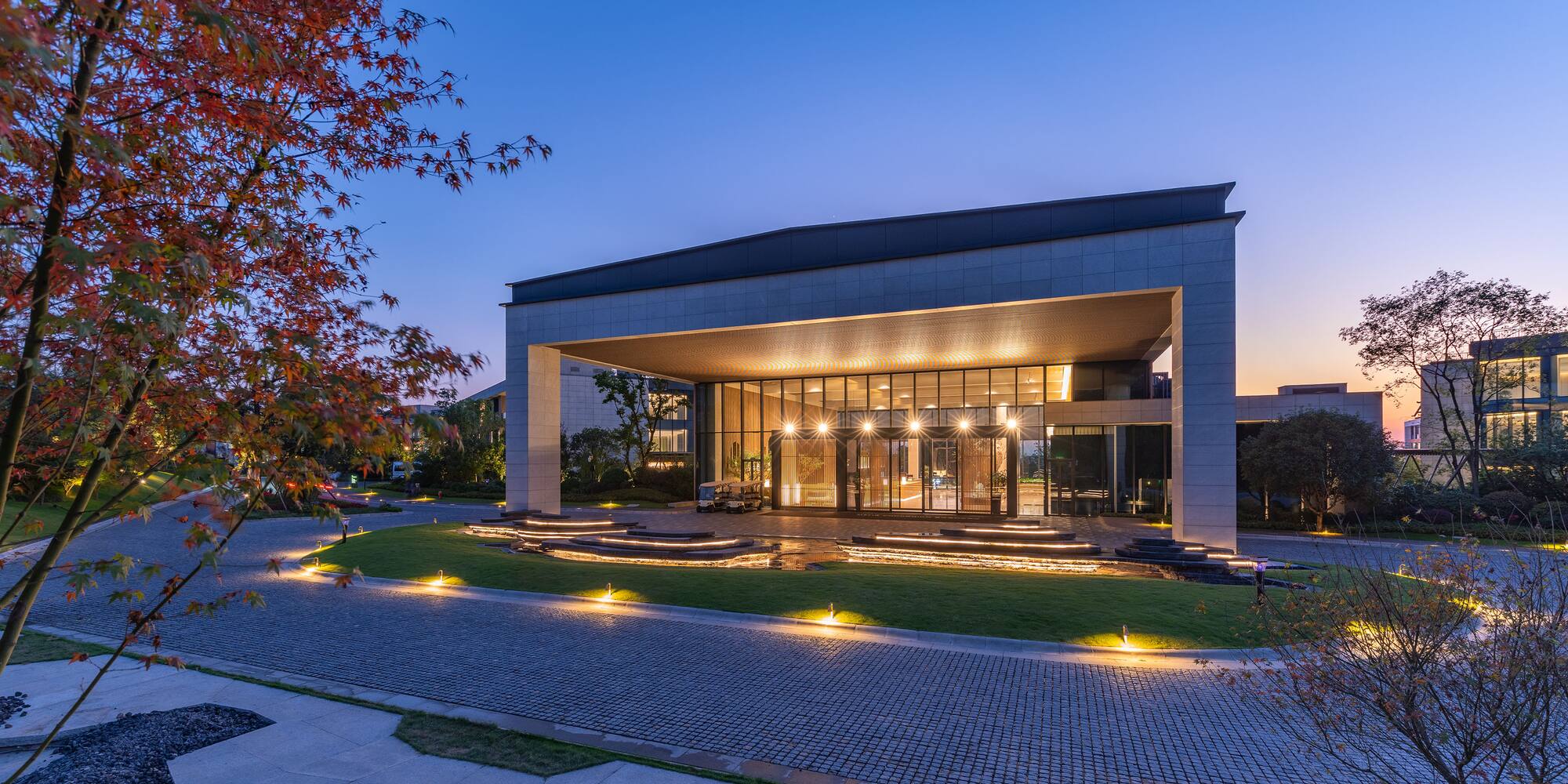 a building with a glass wall and a walkway