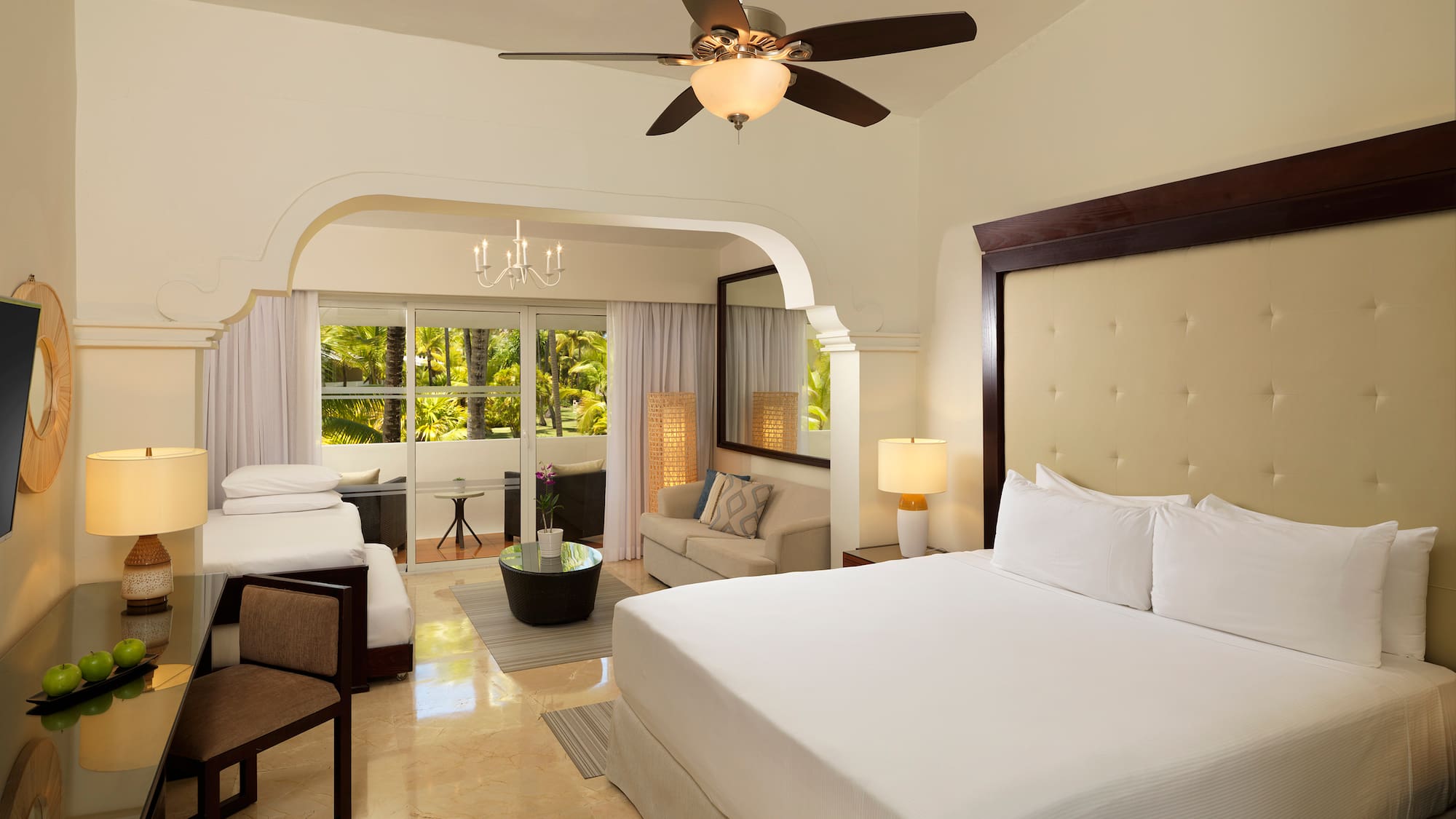 a room with a bed and a ceiling fan