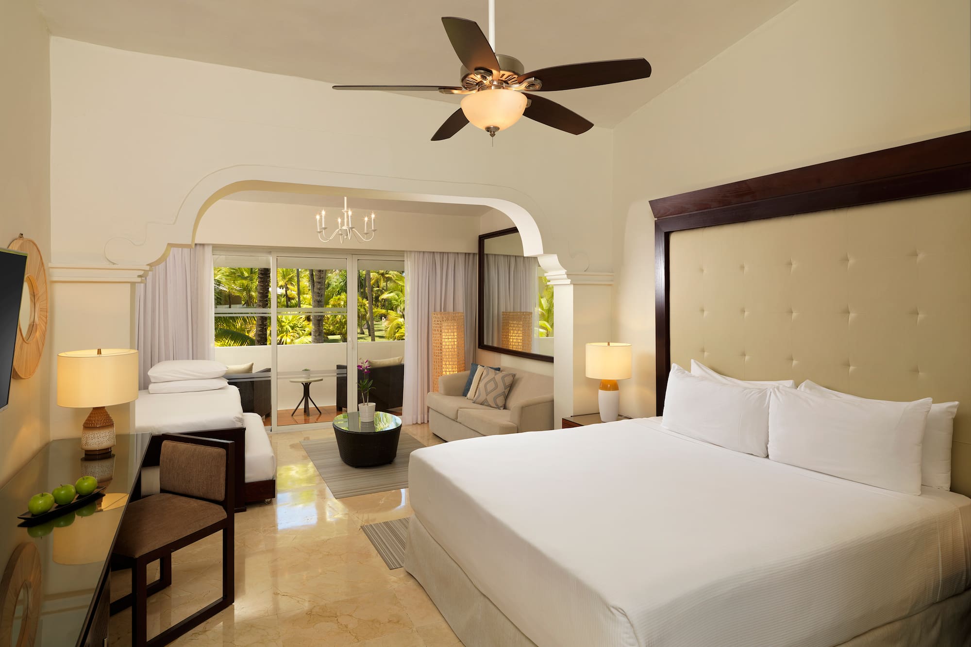 a room with a bed and a ceiling fan