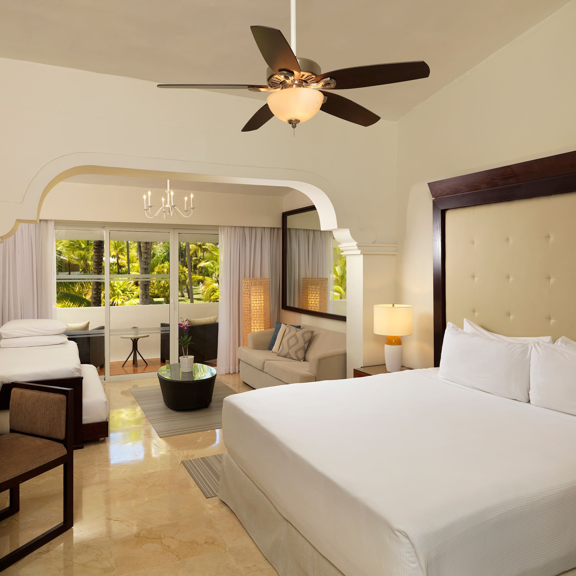 a room with a bed and a ceiling fan