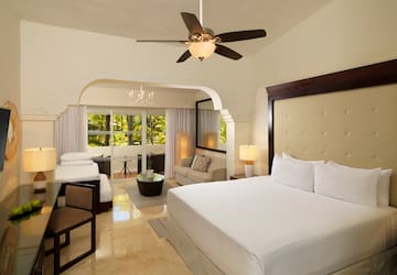 a room with a bed and a ceiling fan