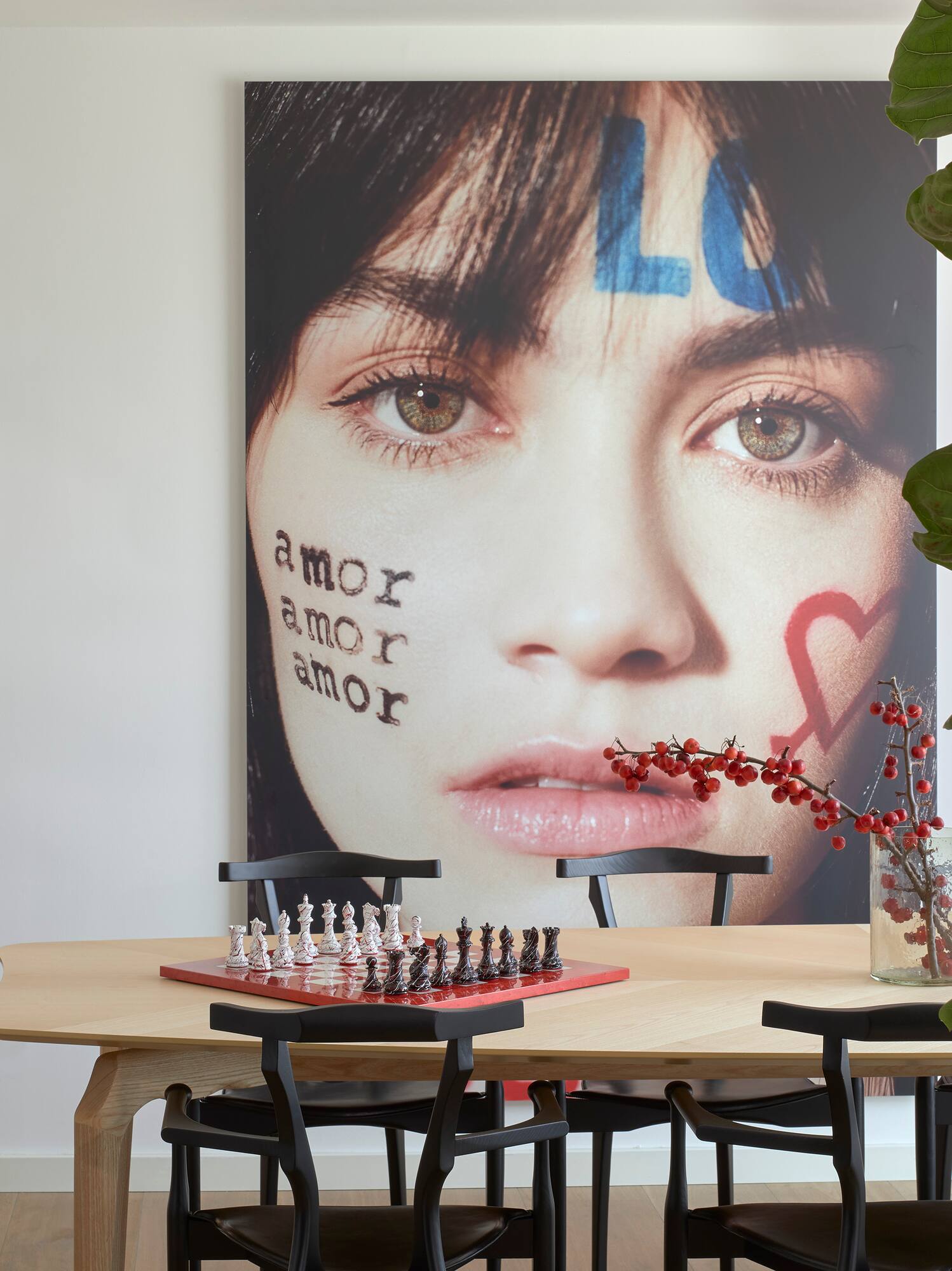a table with chess board and a picture of a woman's face