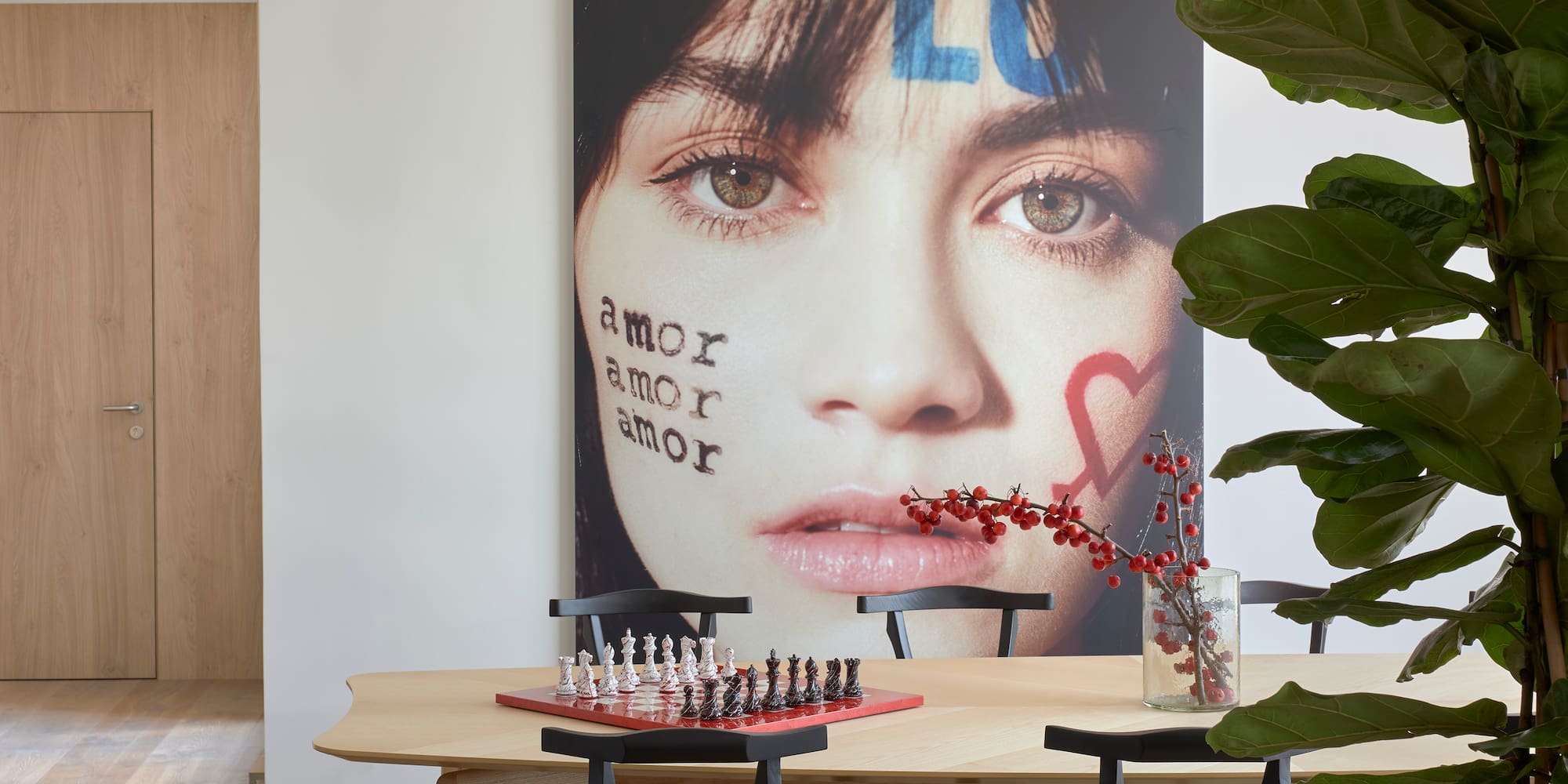a table with chess board and a picture of a woman's face
