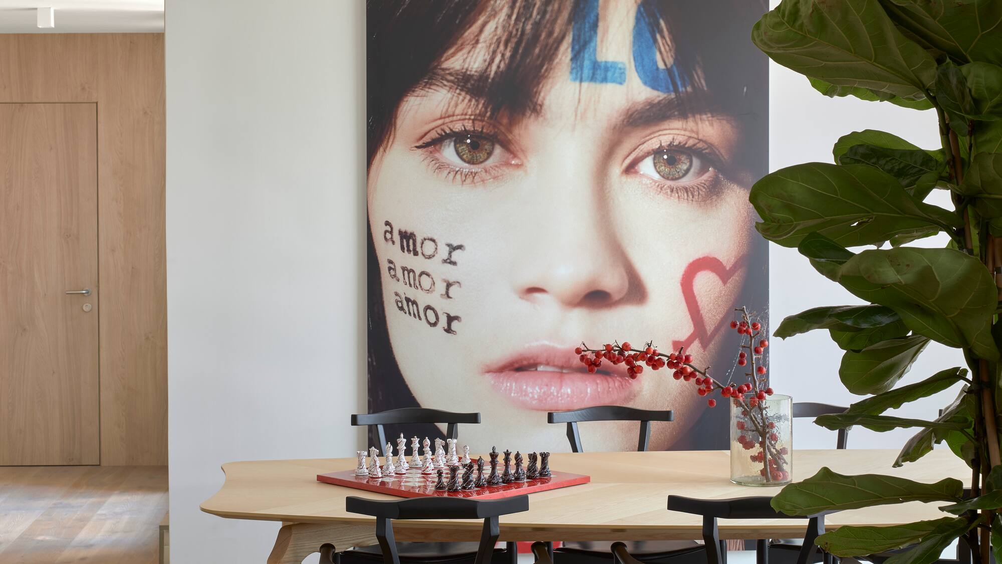 a table with chess board and a picture of a woman's face