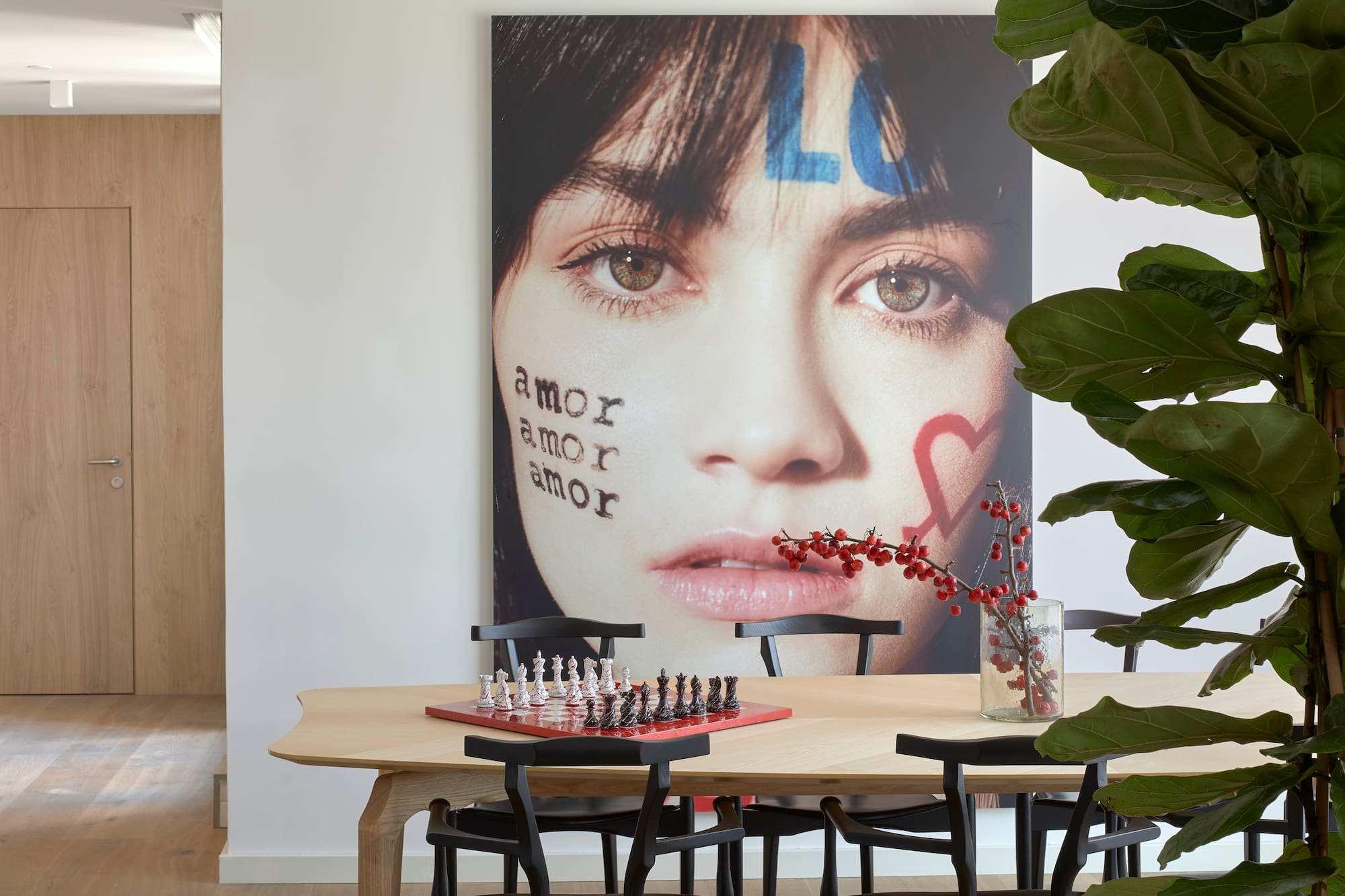 a table with chess board and a picture of a woman's face