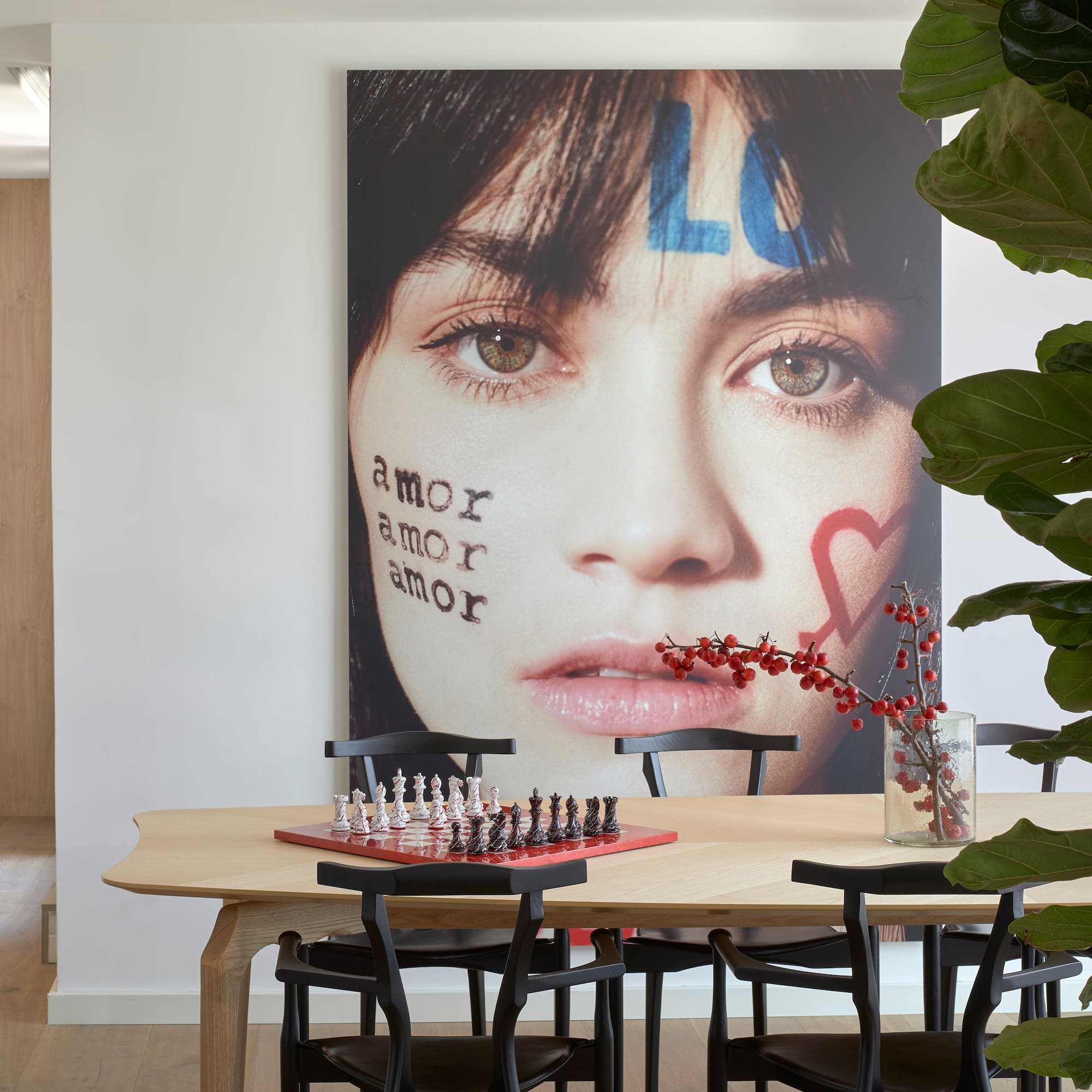 a table with chess board and a picture of a woman's face