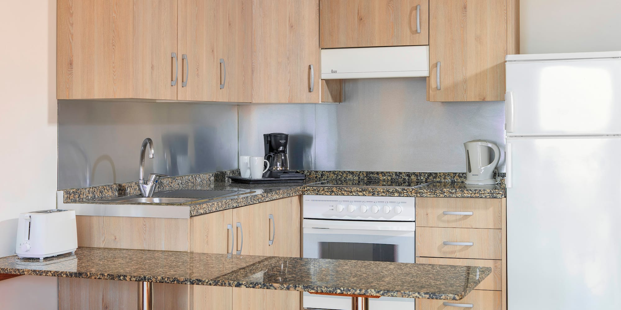 a kitchen with a counter top and stools