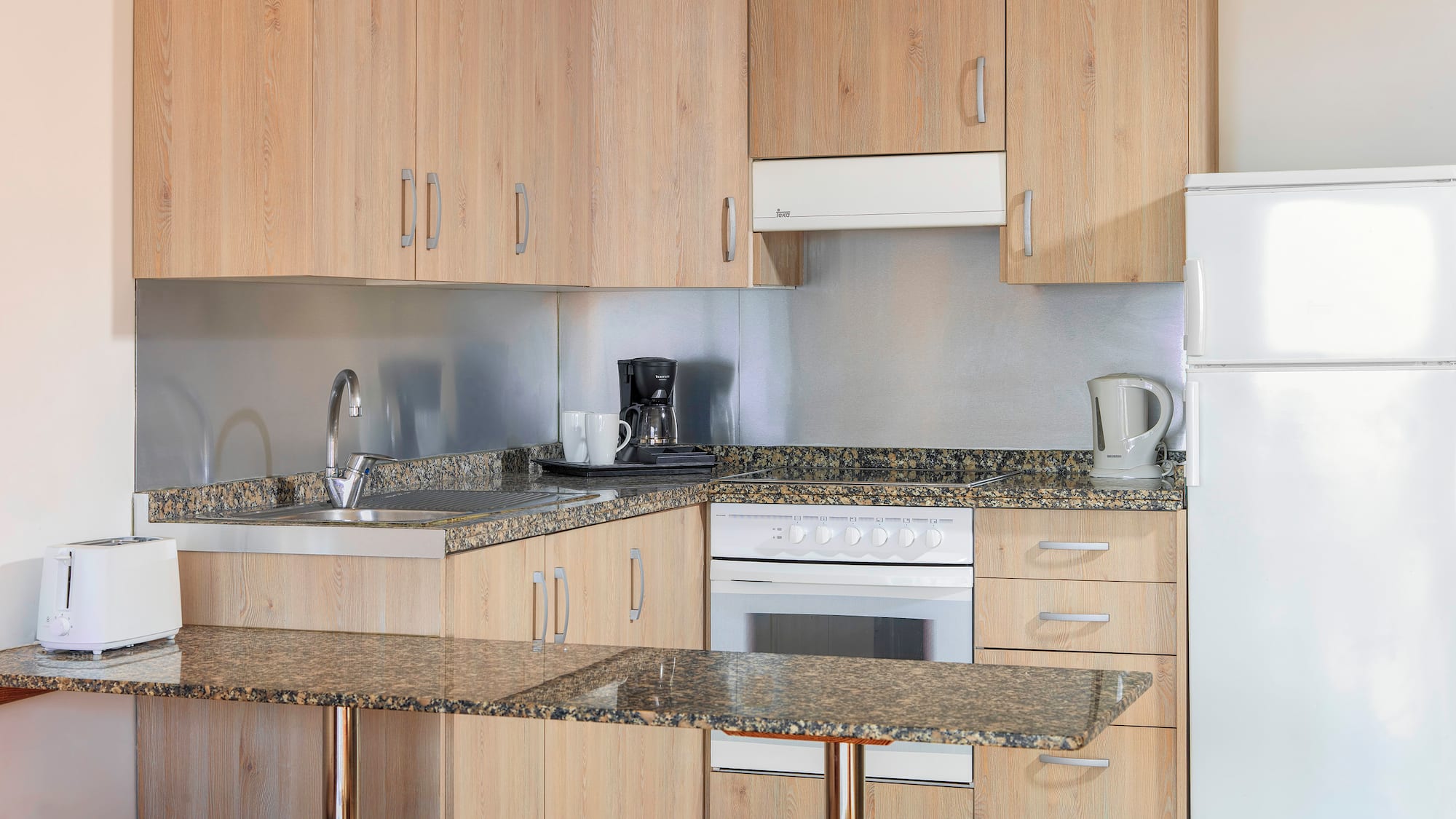a kitchen with a counter top and stools