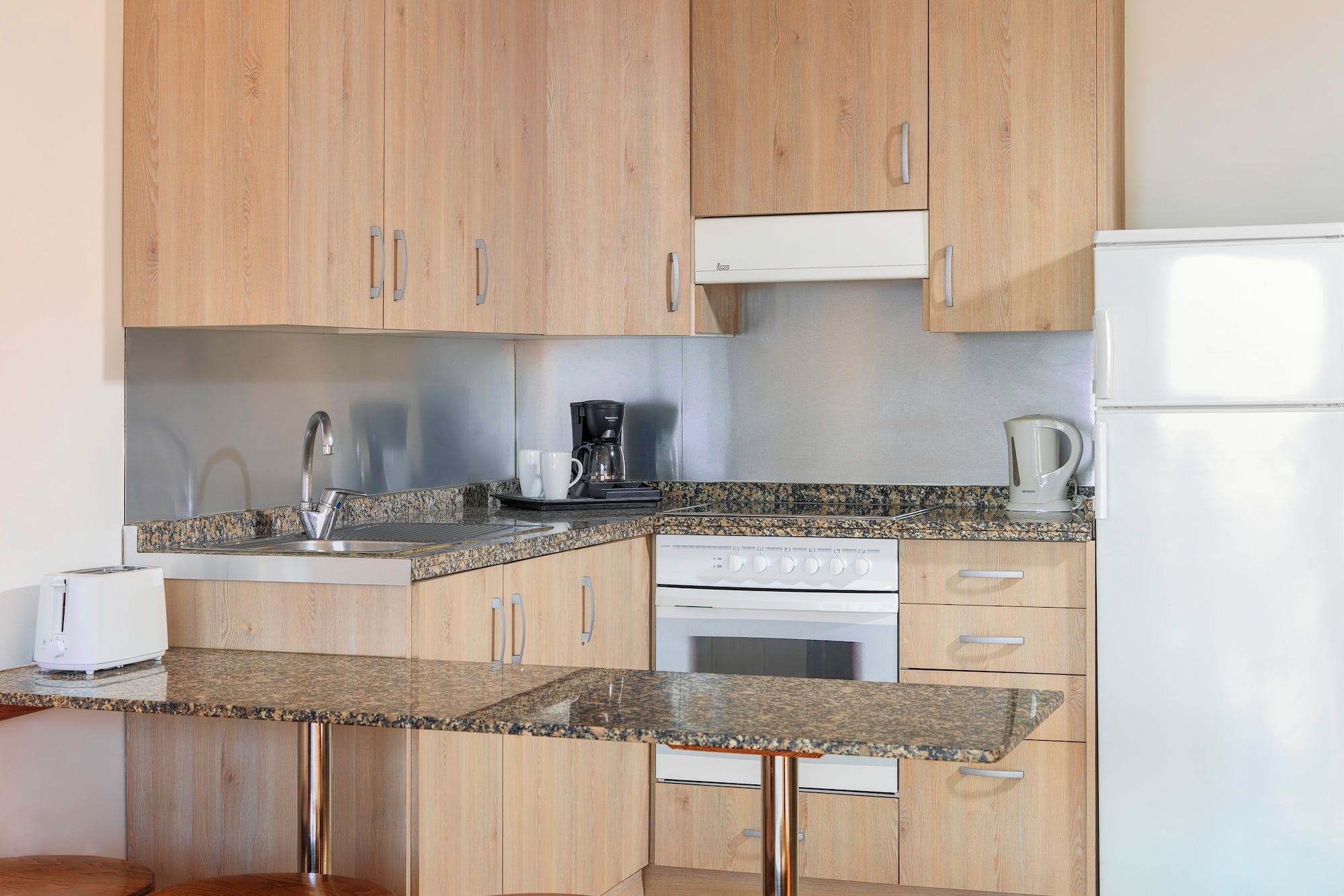 a kitchen with a counter top and stools