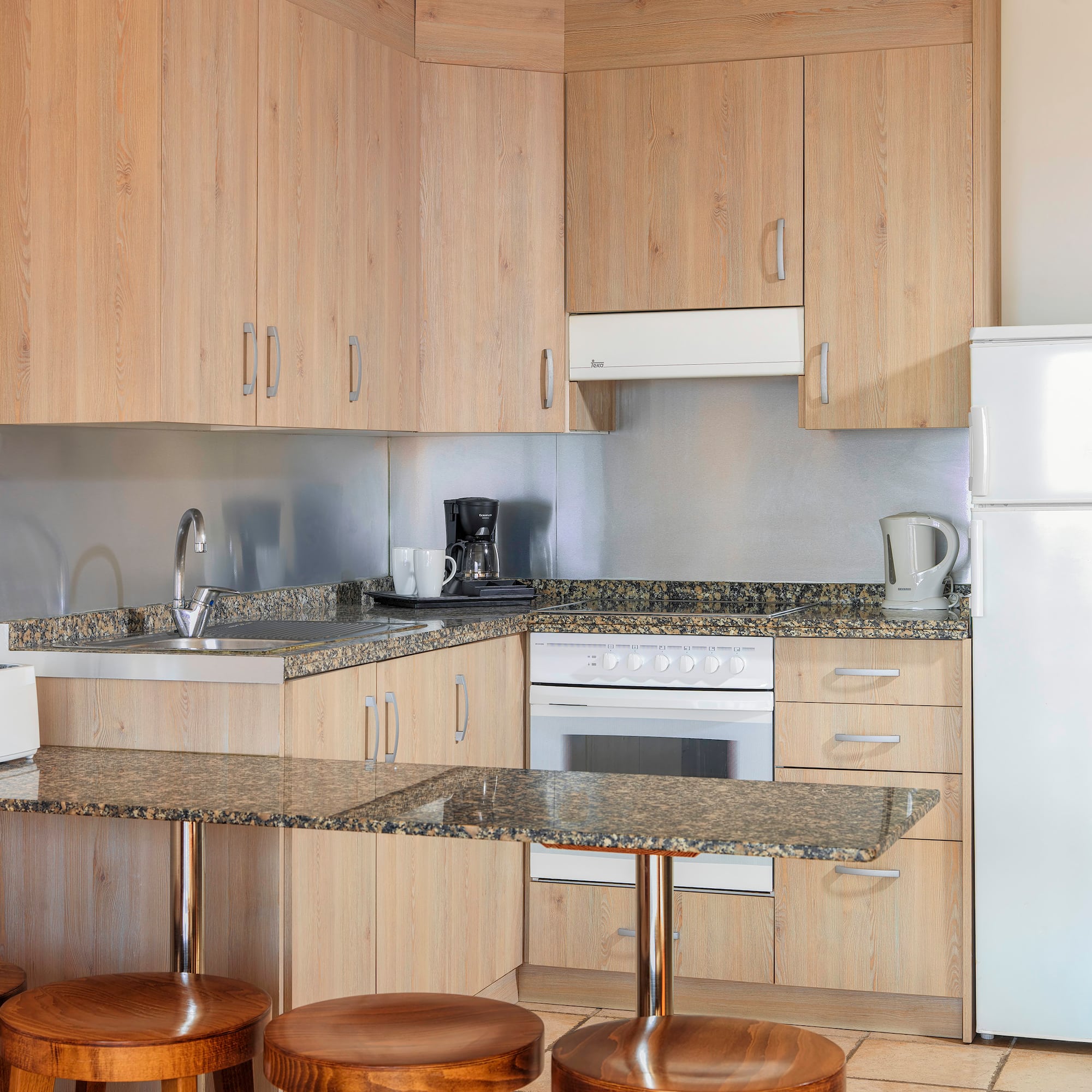 a kitchen with a counter top and stools