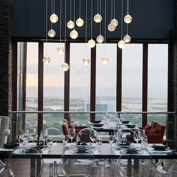 a dining room with a large window and a view of the ocean
