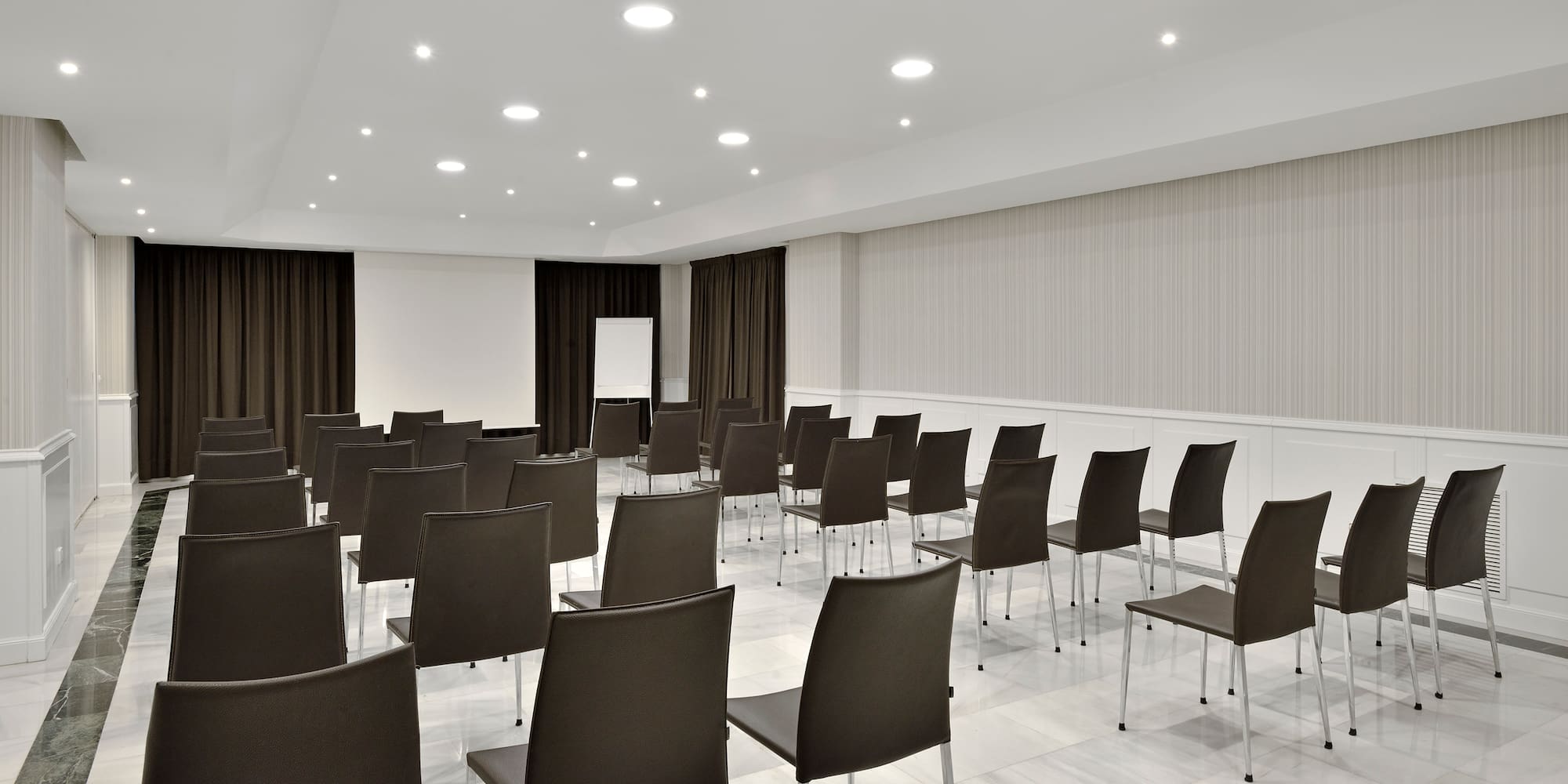 a room with chairs and a screen