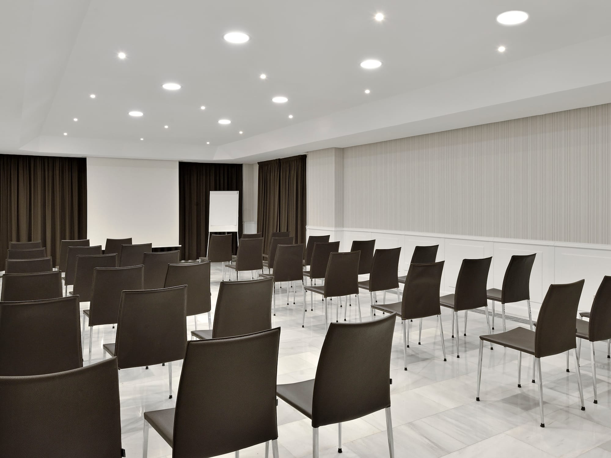 a room with chairs and a screen