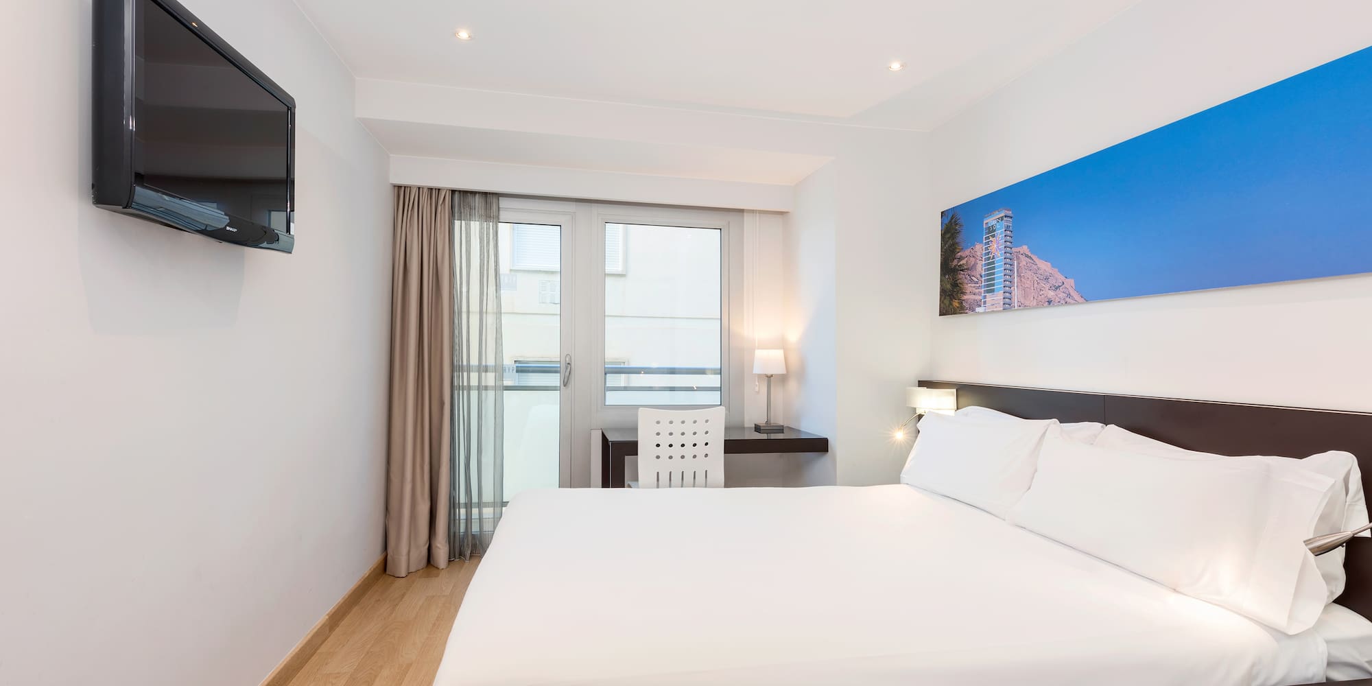 a bedroom with a bed and a television