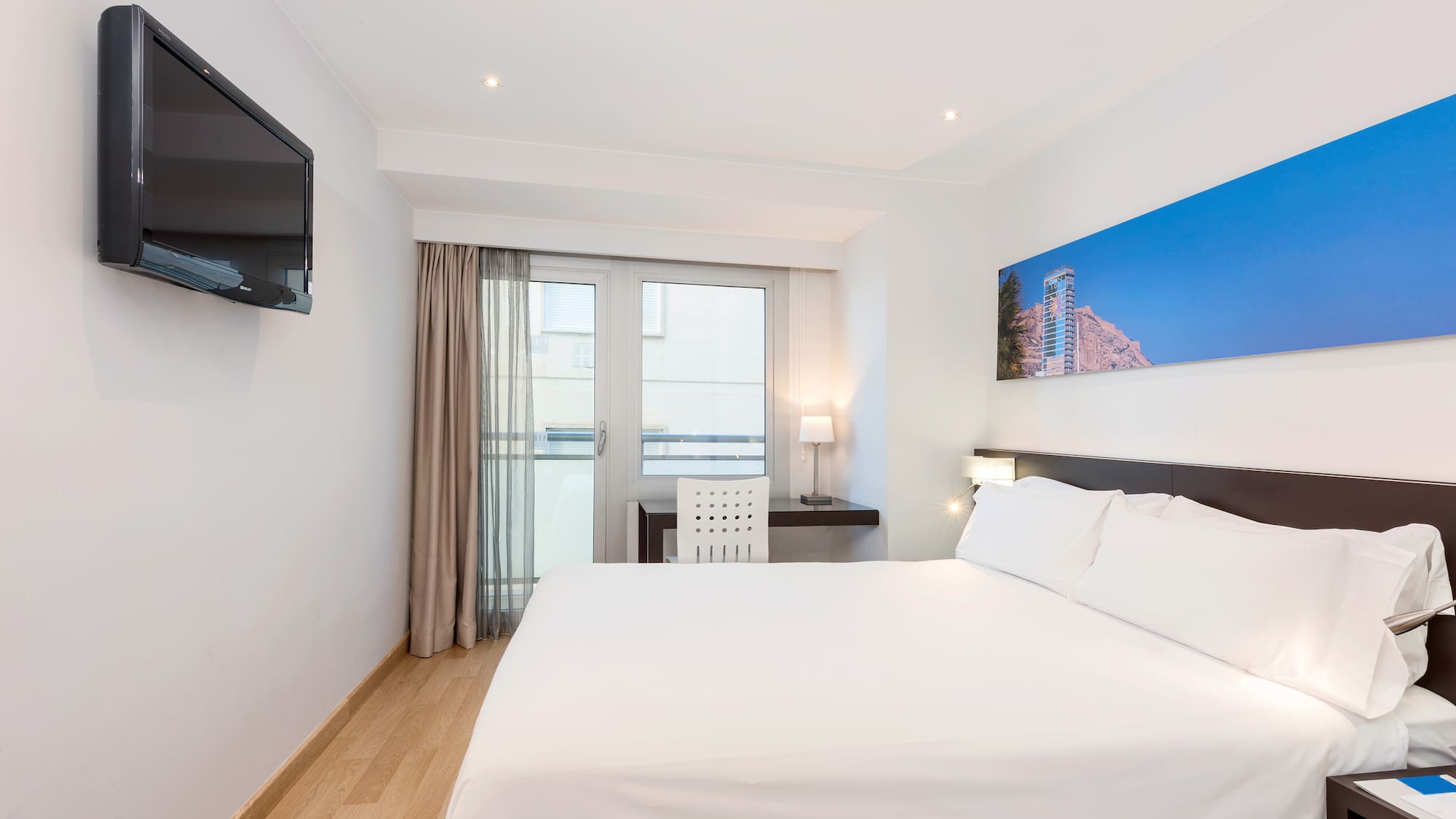 a bedroom with a bed and a television