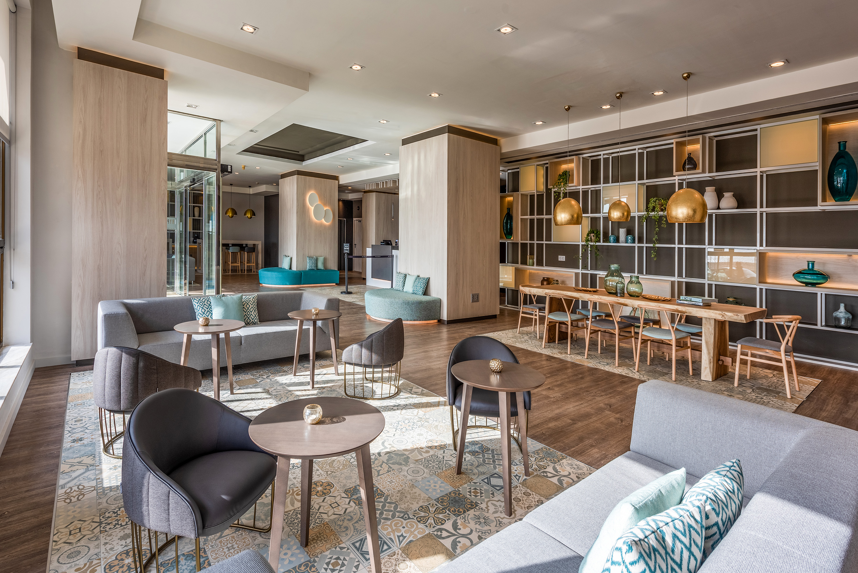 Bright, spacious hotel lobby featuring comfortable seating and modern decor.