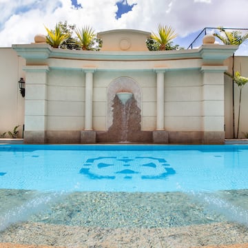 a pool with a fountain in the middle
