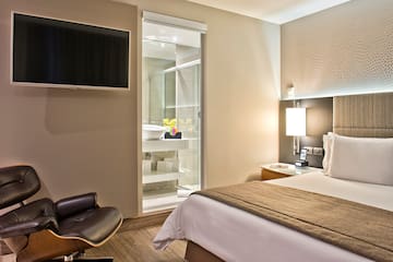 a bedroom with a tv and a bed